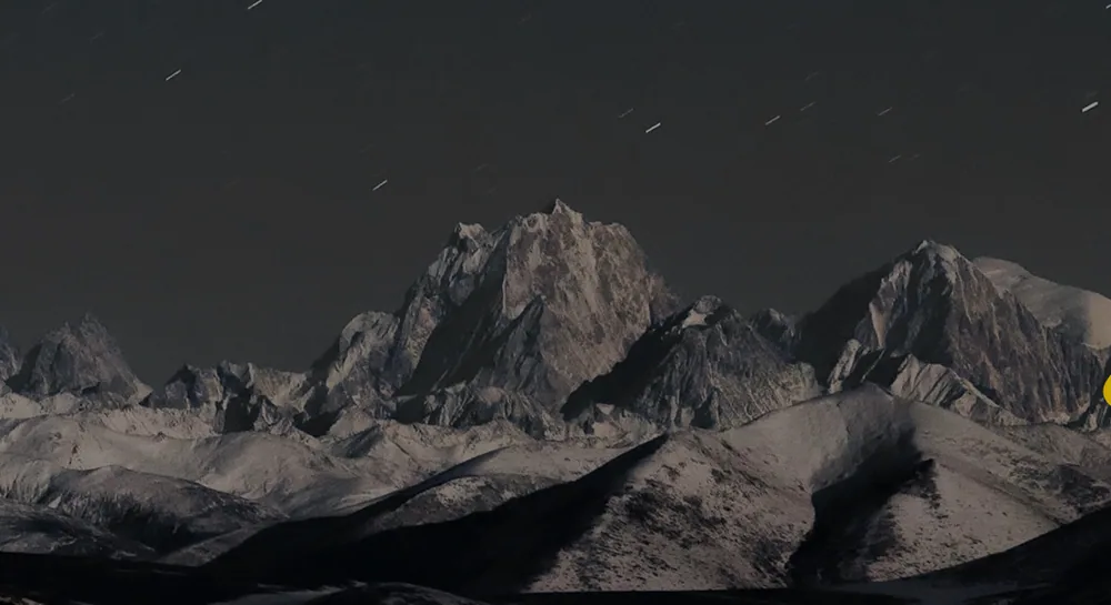 Snow-covered peaks under a night sky